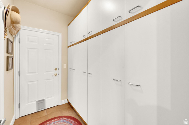 7740 Keswick Road Sandy, UT 84093 - Photo 25 of 74 White paneled door with a brass-finish doorknob and a pet door insert