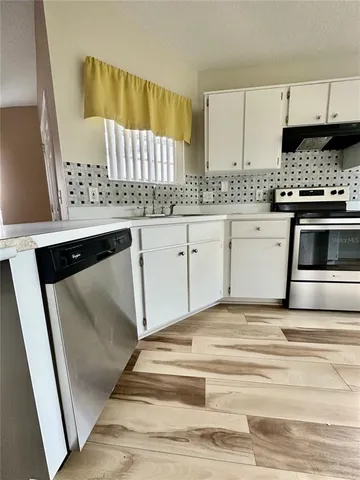 a kitchen with granite countertop a sink and a stove