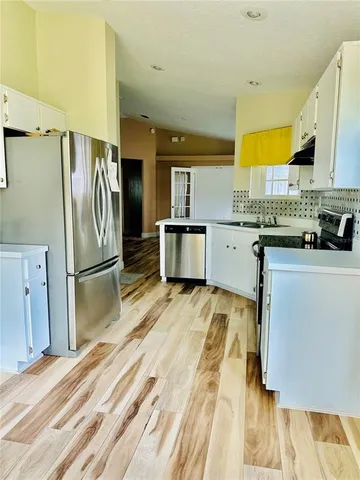 a kitchen with a sink stove and refrigerator