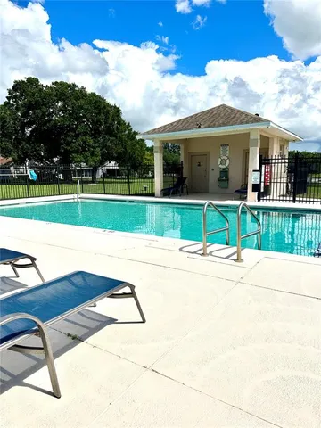a view of a house with a big yard and potted plants
