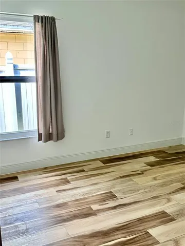 a view of wooden floor and a window