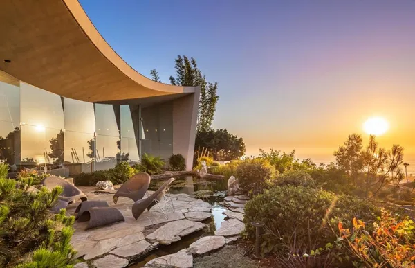 a terrace with outdoor seating and city view