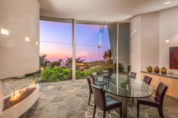 a dining room with a wooden table and chairs