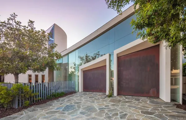 a outdoor space with patio the couches and a dining table with large trees