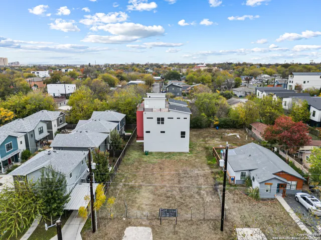 an aerial view of residential houses with outdoor space