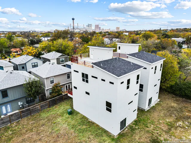 an aerial view of residential houses with yard