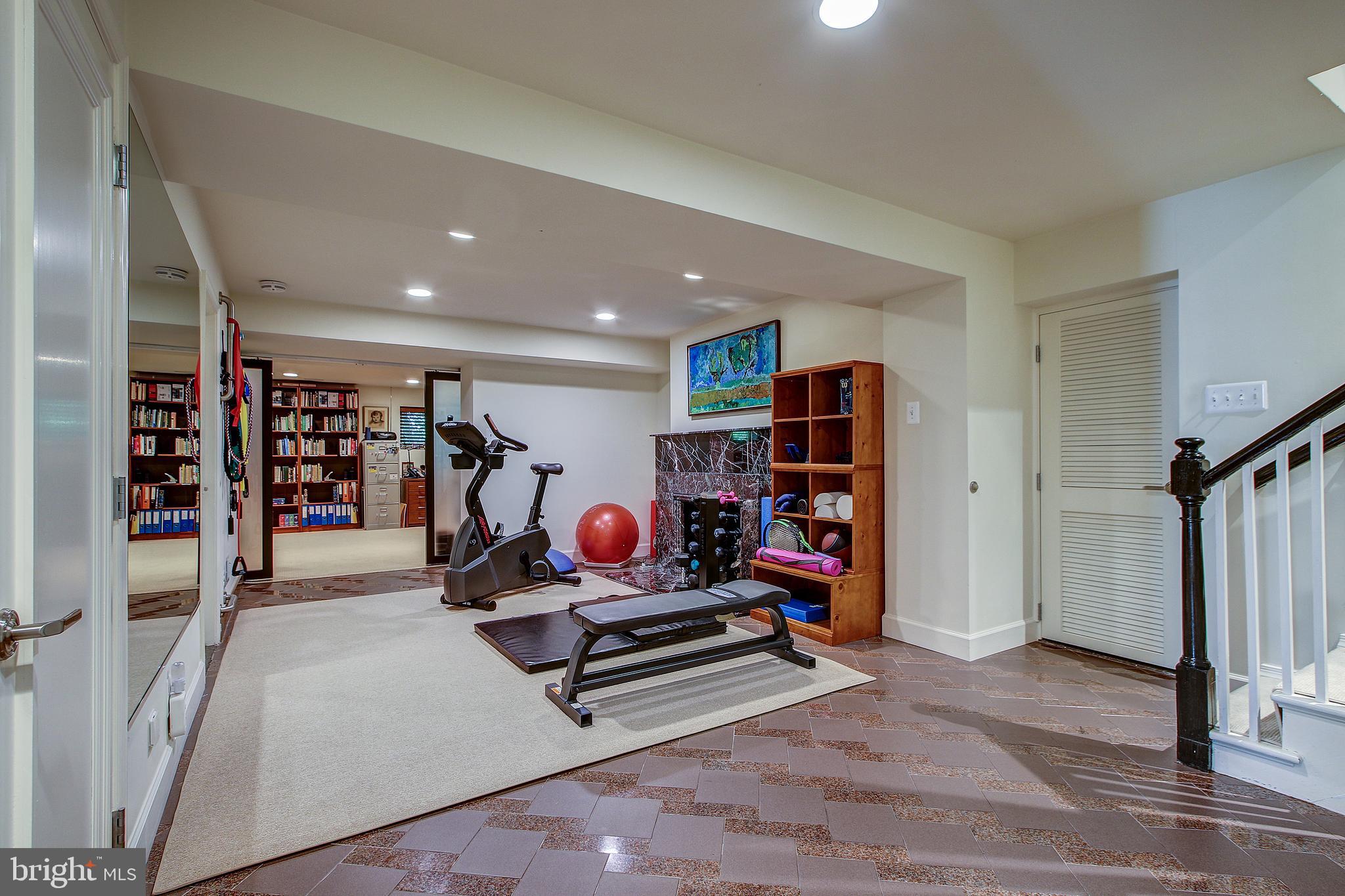 7211 Fairfax Road Bethesda, MD 20814 - Photo 29 of 39 Lower Level Common Area with Marble Fireplace