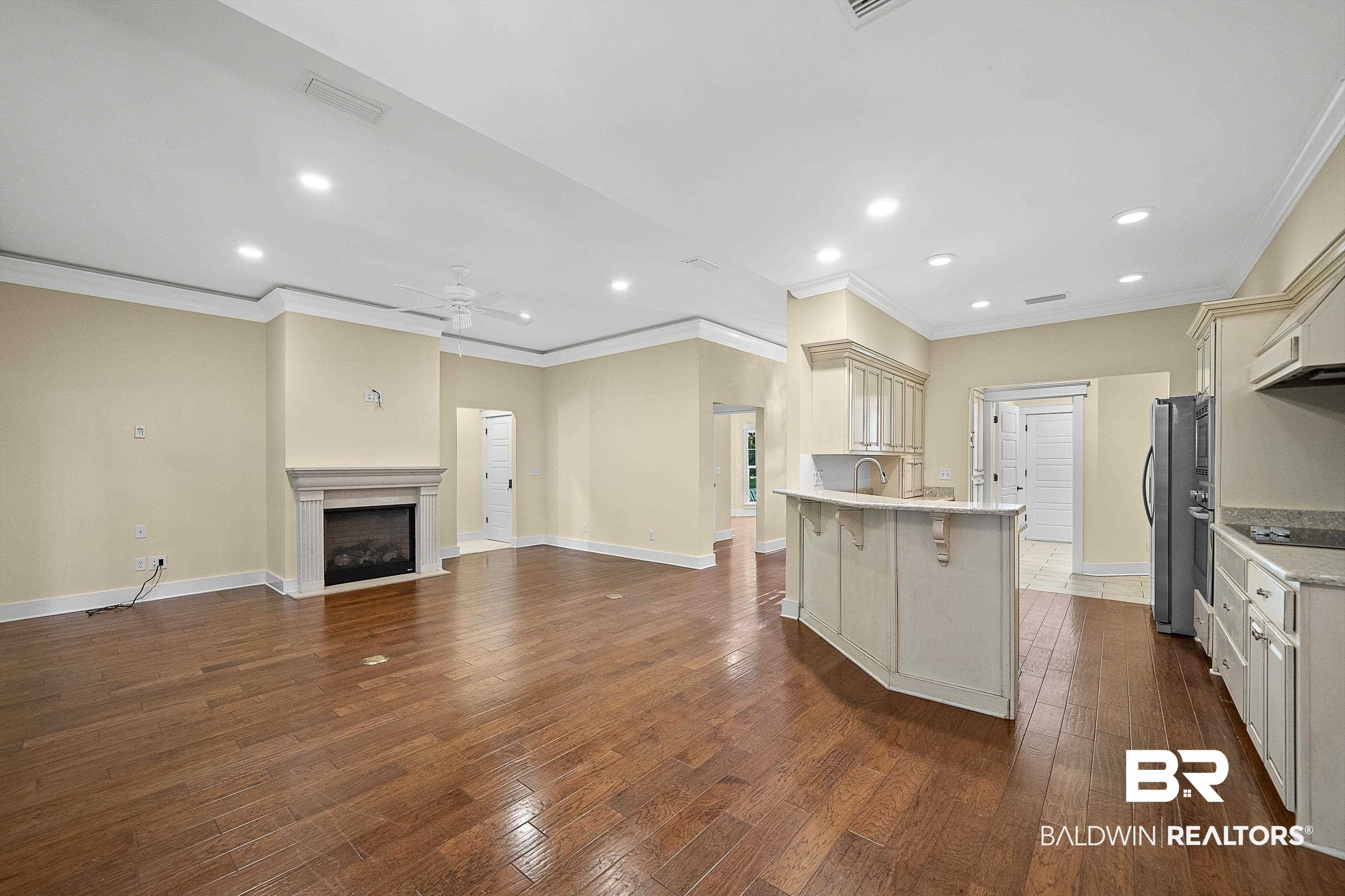 356 Liberty Street Fairhope, AL 36532 - Photo 39 of 39 Kitchen featuring a kitchen bar, crown molding, a peninsula, recessed lighting, and open floor plan