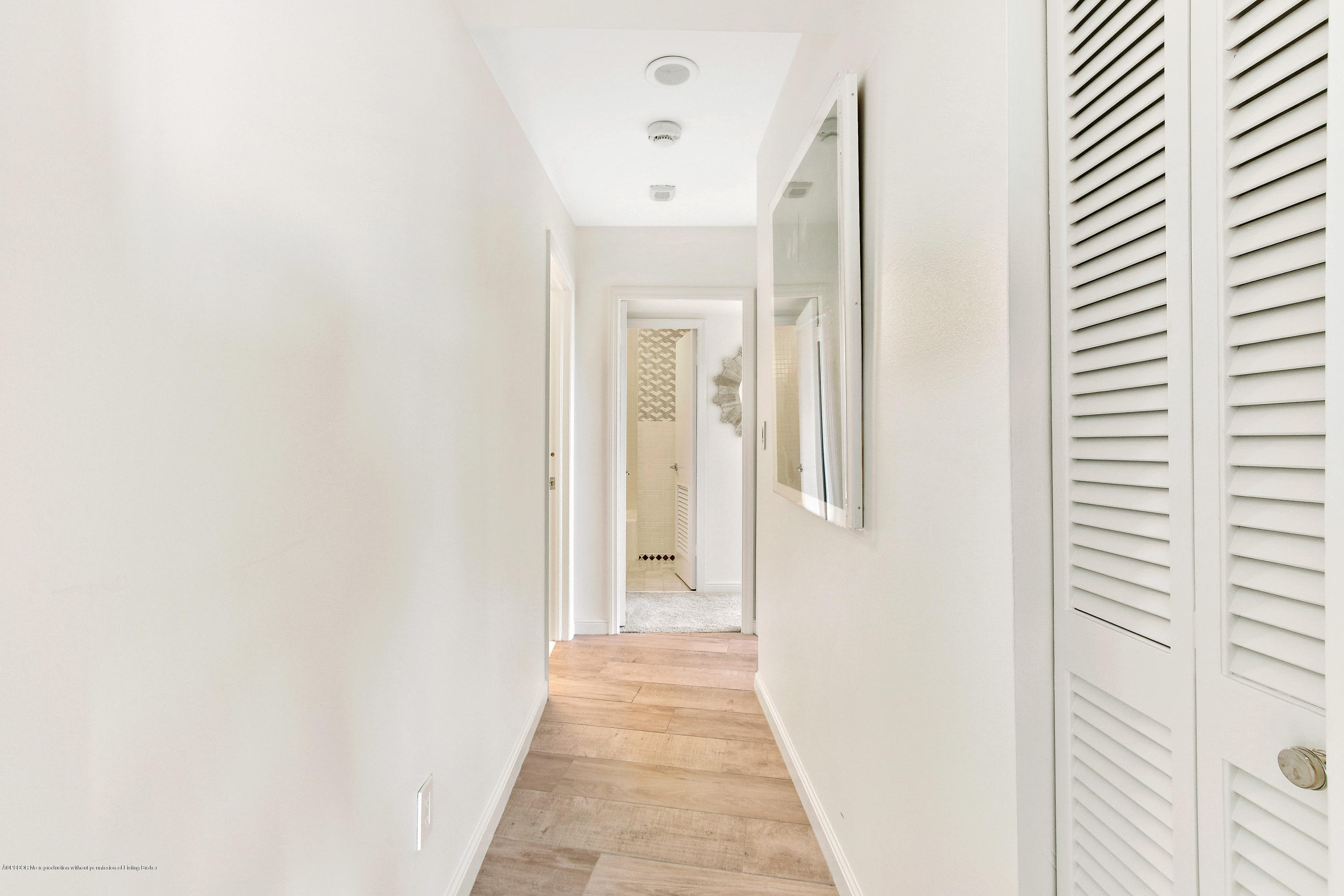 44 Cocoanut Row, Unit 522B Palm Beach, FL 33480 - Photo 11 of 15 a view of a hallway with wooden floor and a bathroom