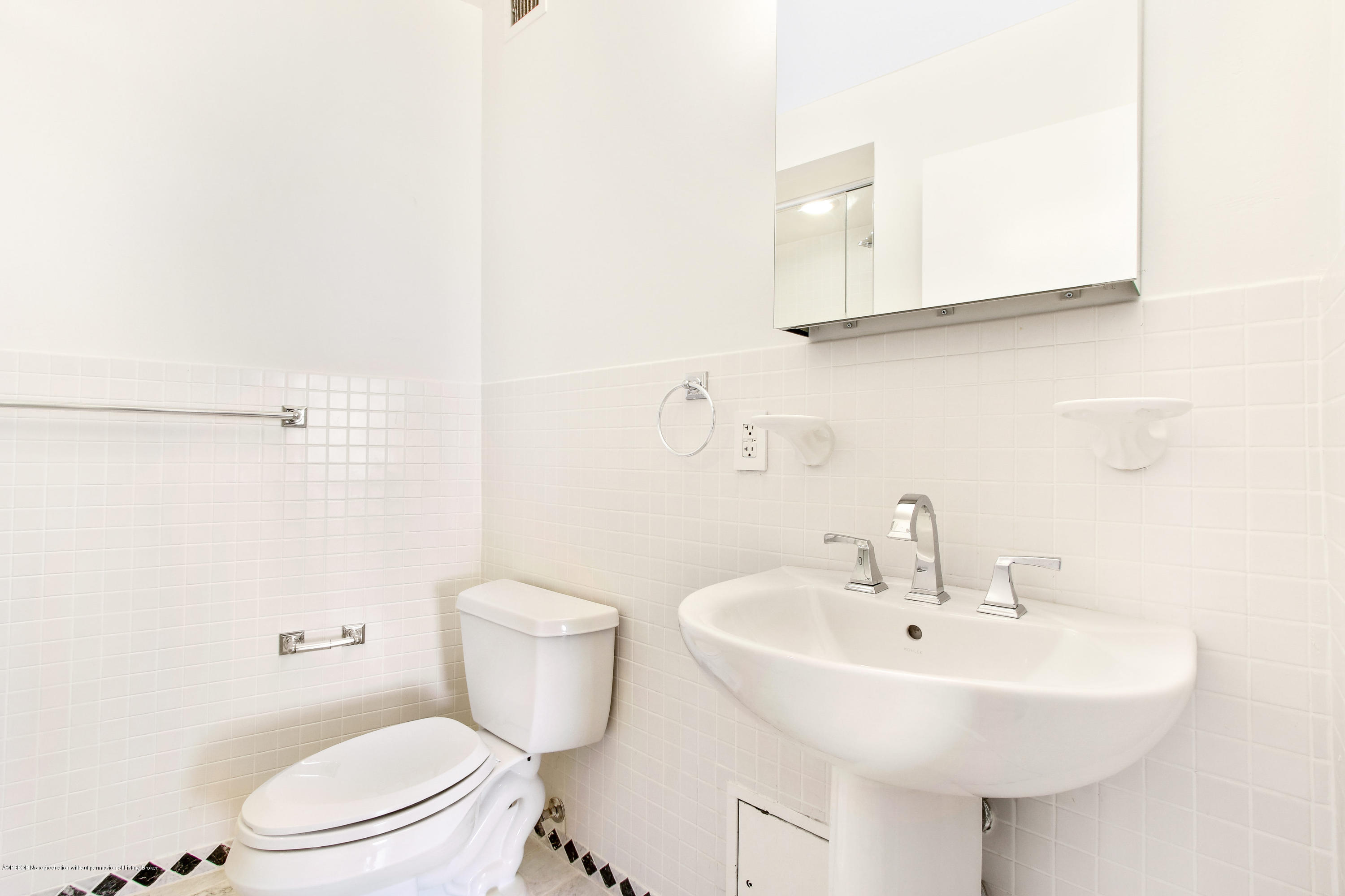 44 Cocoanut Row, Unit 522B Palm Beach, FL 33480 - Photo 15 of 15 a bathroom with a sink a toilet and mirror