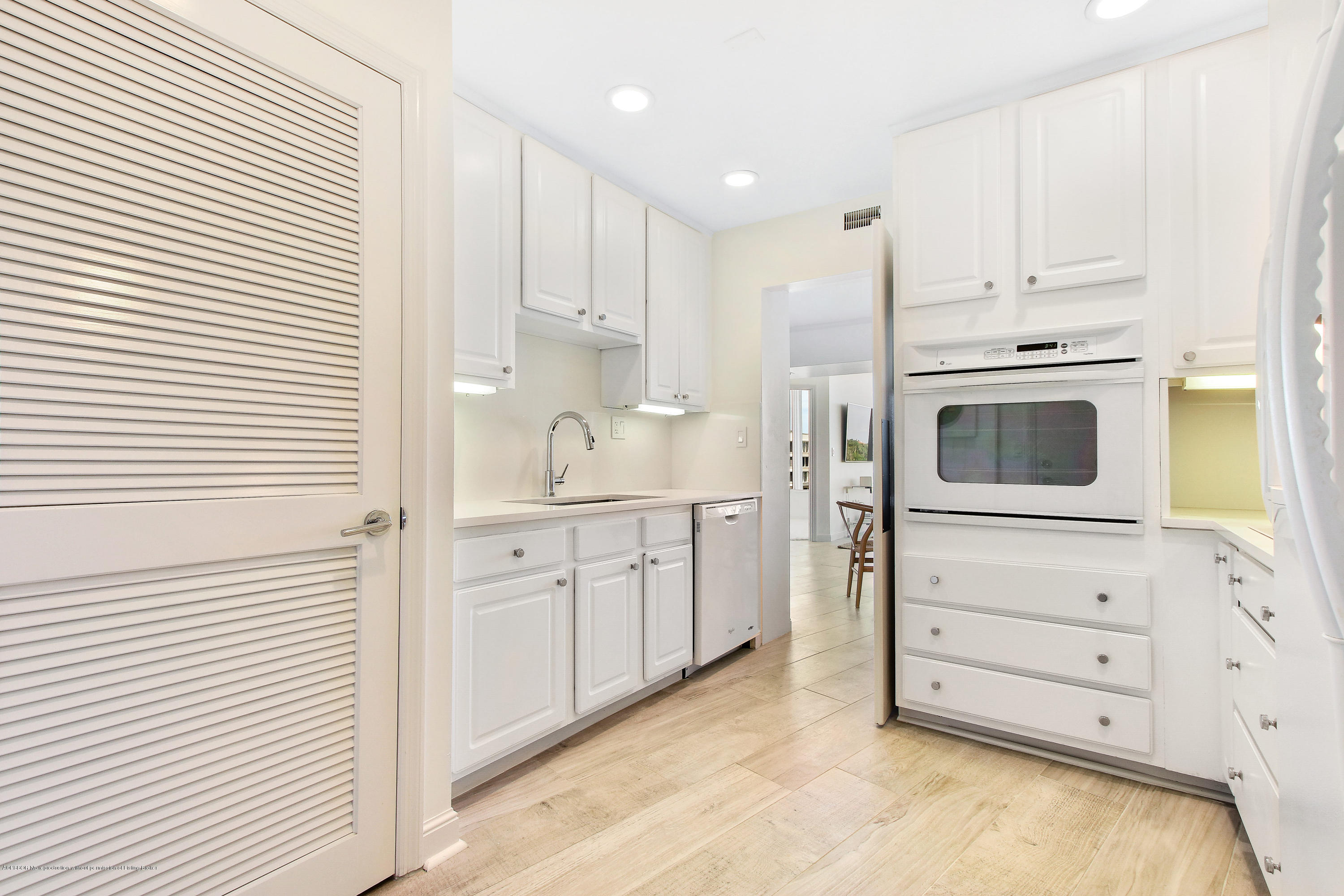 44 Cocoanut Row, Unit 522B Palm Beach, FL 33480 - Photo 7 of 15 a kitchen with granite countertop white cabinets and white appliances
