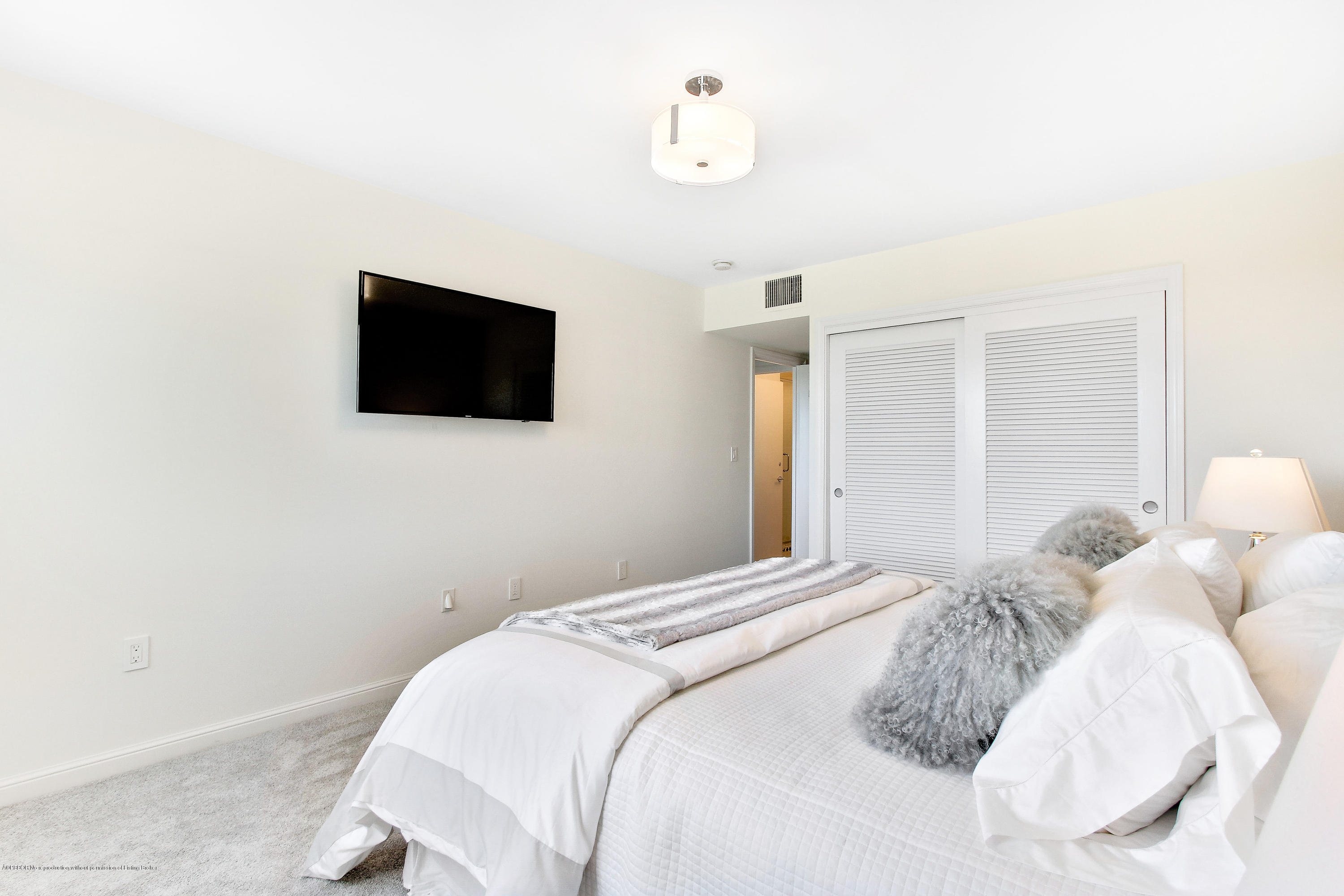 44 Cocoanut Row, Unit 522B Palm Beach, FL 33480 - Photo 10 of 15 a bedroom with a bed and a flat screen tv