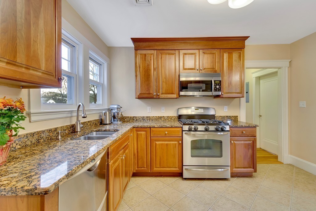 73 Athelstane Road, Unit 73 Newton, MA 02459 - Photo 4 of 20 a kitchen with stainless steel appliances granite countertop a stove a sink and a microwave