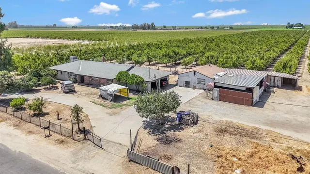 an aerial view of a house with a garden and lake view