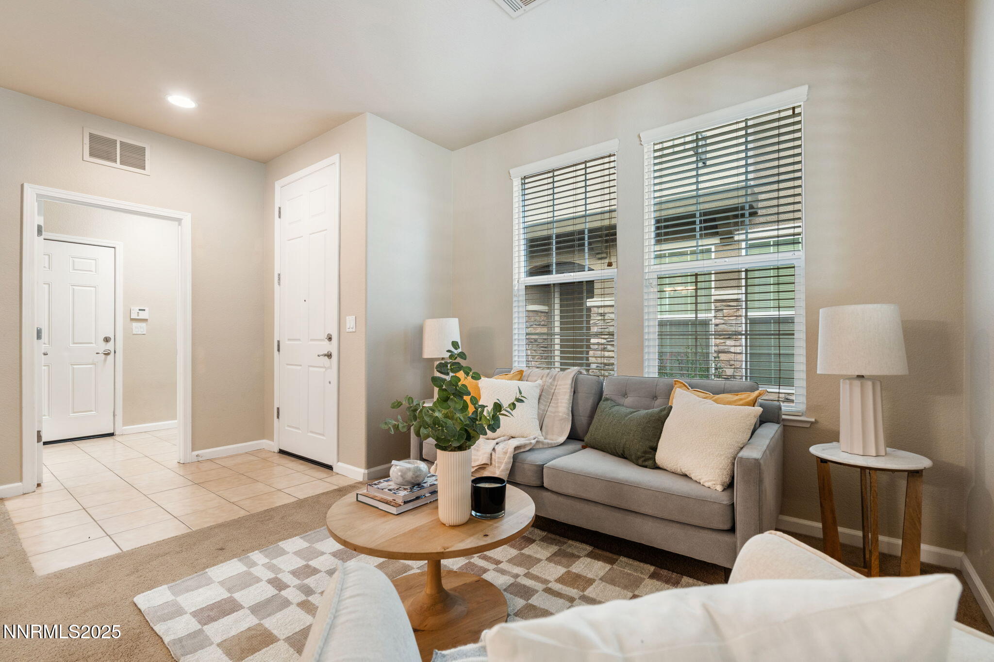 a living room with furniture and a potted plant