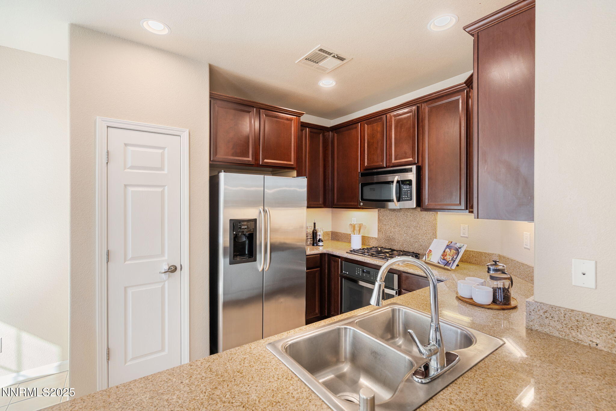 1865 Wind Ranch Road, Unit A Reno, NV 89521 - Photo 11 of 30 a kitchen with stainless steel appliances granite countertop a refrigerator a stove and a sink with wooden floor