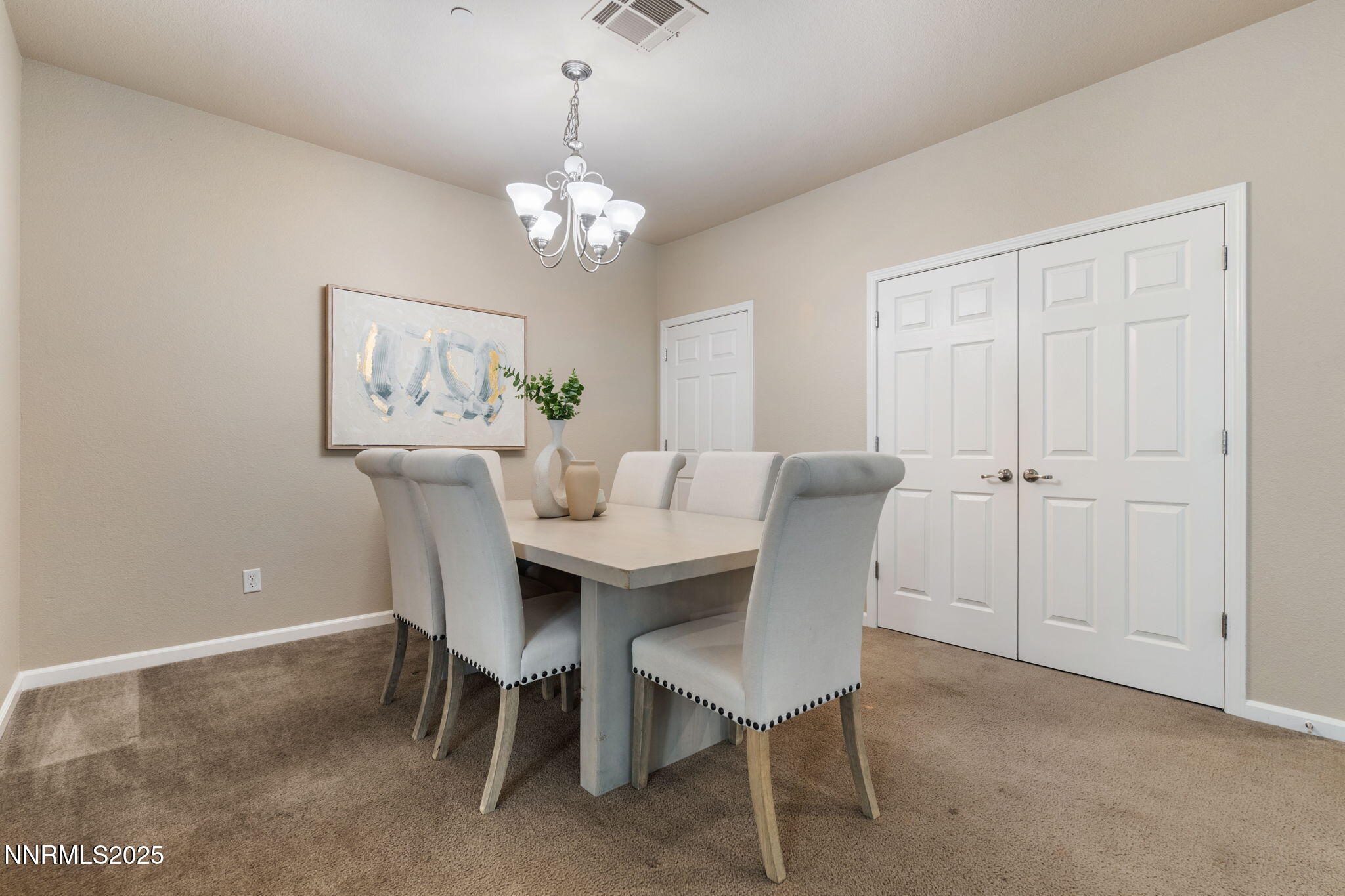 1865 Wind Ranch Road, Unit A Reno, NV 89521 - Photo 12 of 30 a view of a dining room with furniture a chandelier and a window