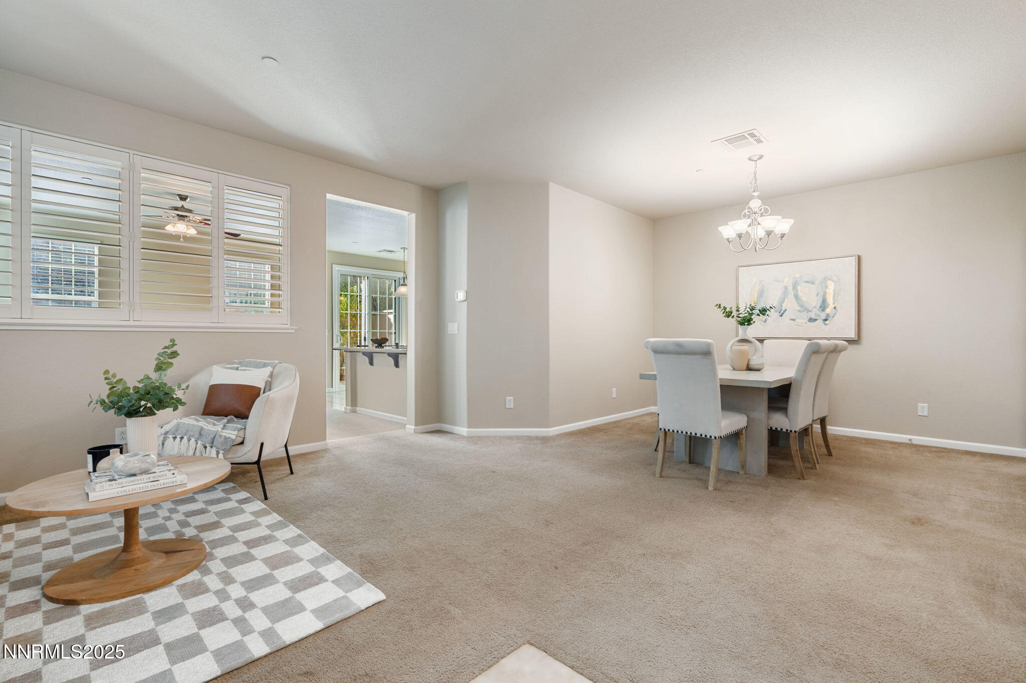 1865 Wind Ranch Road, Unit A Reno, NV 89521 - Photo 13 of 30 a living room with furniture a dining table and a potted plant