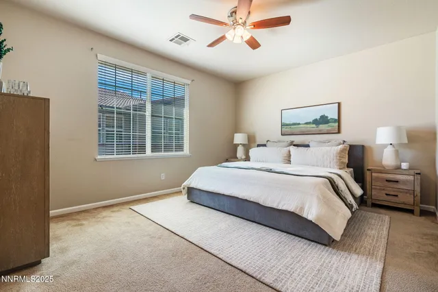 a bedroom with a large bed and a window