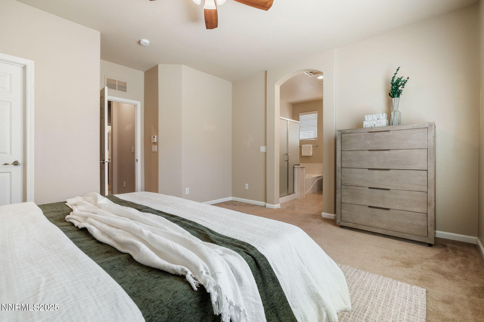 1865 Wind Ranch Road, Unit A Reno, NV 89521 - Photo 17 of 30 a bedroom with a bed and a dresser