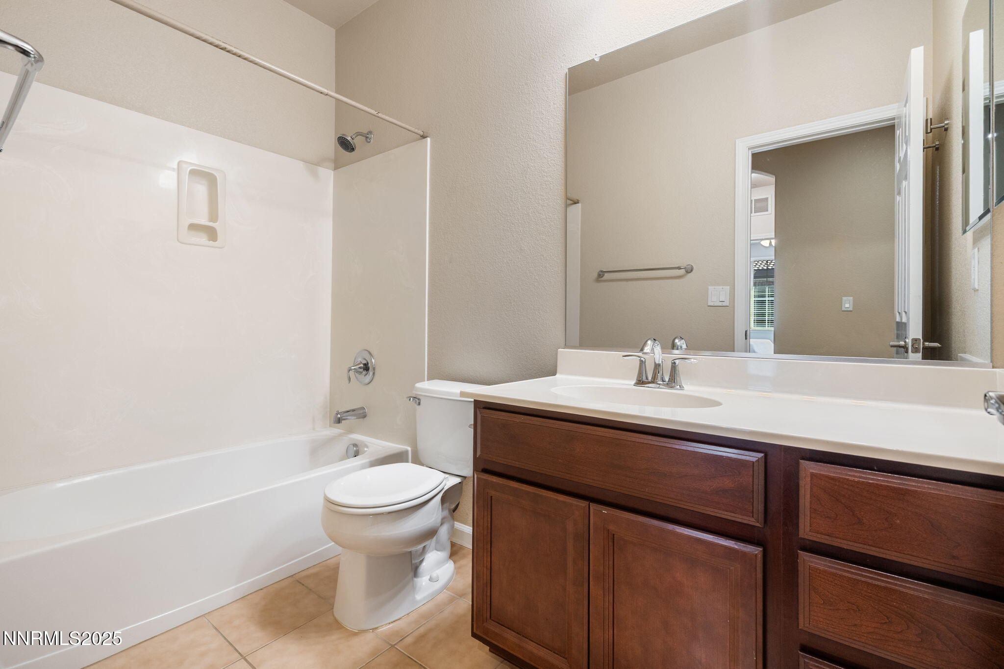 1865 Wind Ranch Road, Unit A Reno, NV 89521 - Photo 22 of 30 a bathroom with a sink a toilet and a large mirror