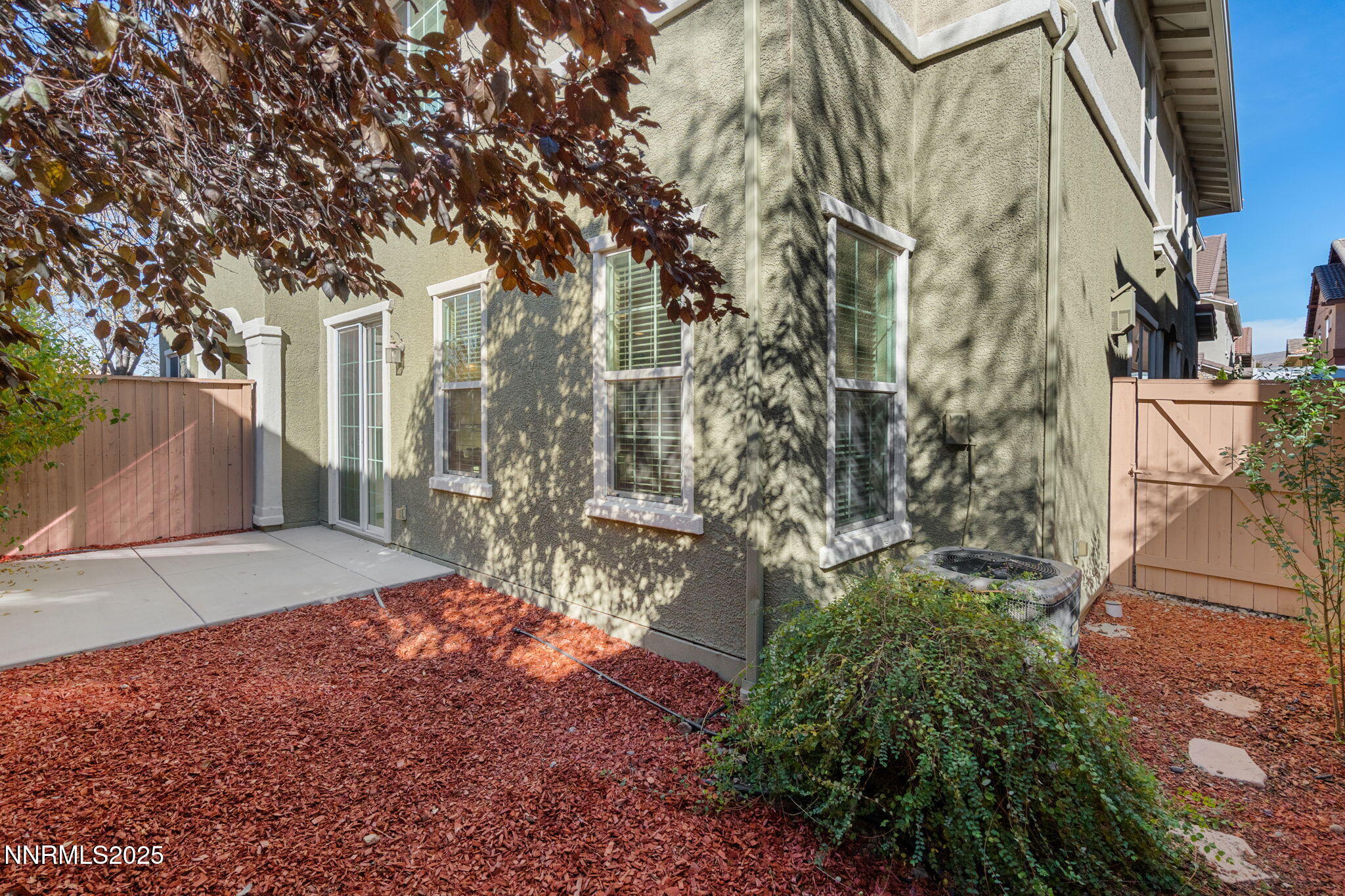 1865 Wind Ranch Road, Unit A Reno, NV 89521 - Photo 28 of 30 a view of a yard with plants and large trees