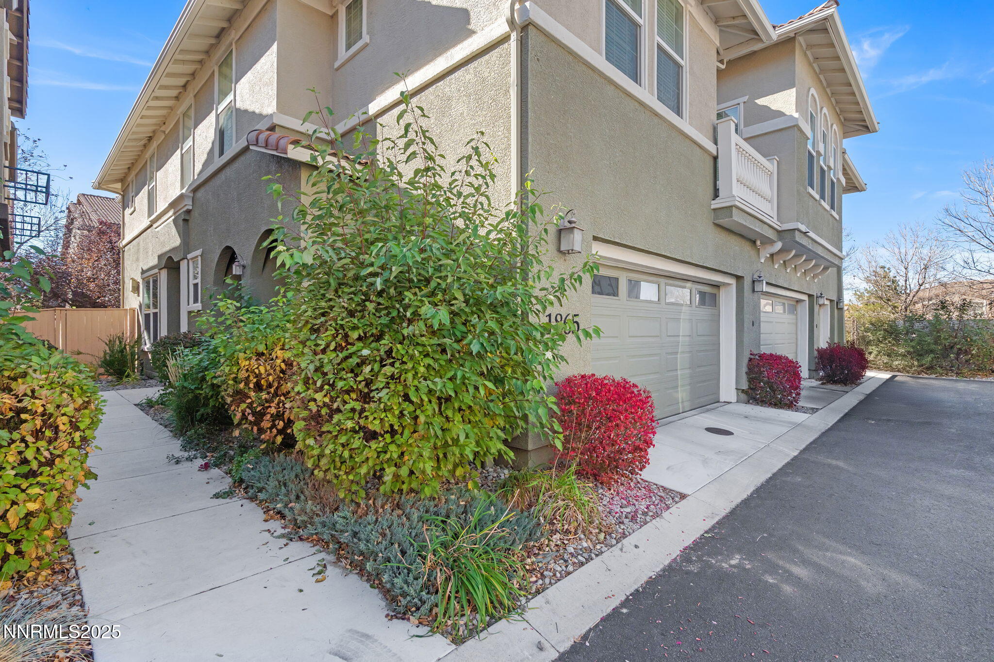 1865 Wind Ranch Road, Unit A Reno, NV 89521 - Photo 3 of 30 a view of a brick house with a yard and potted plants