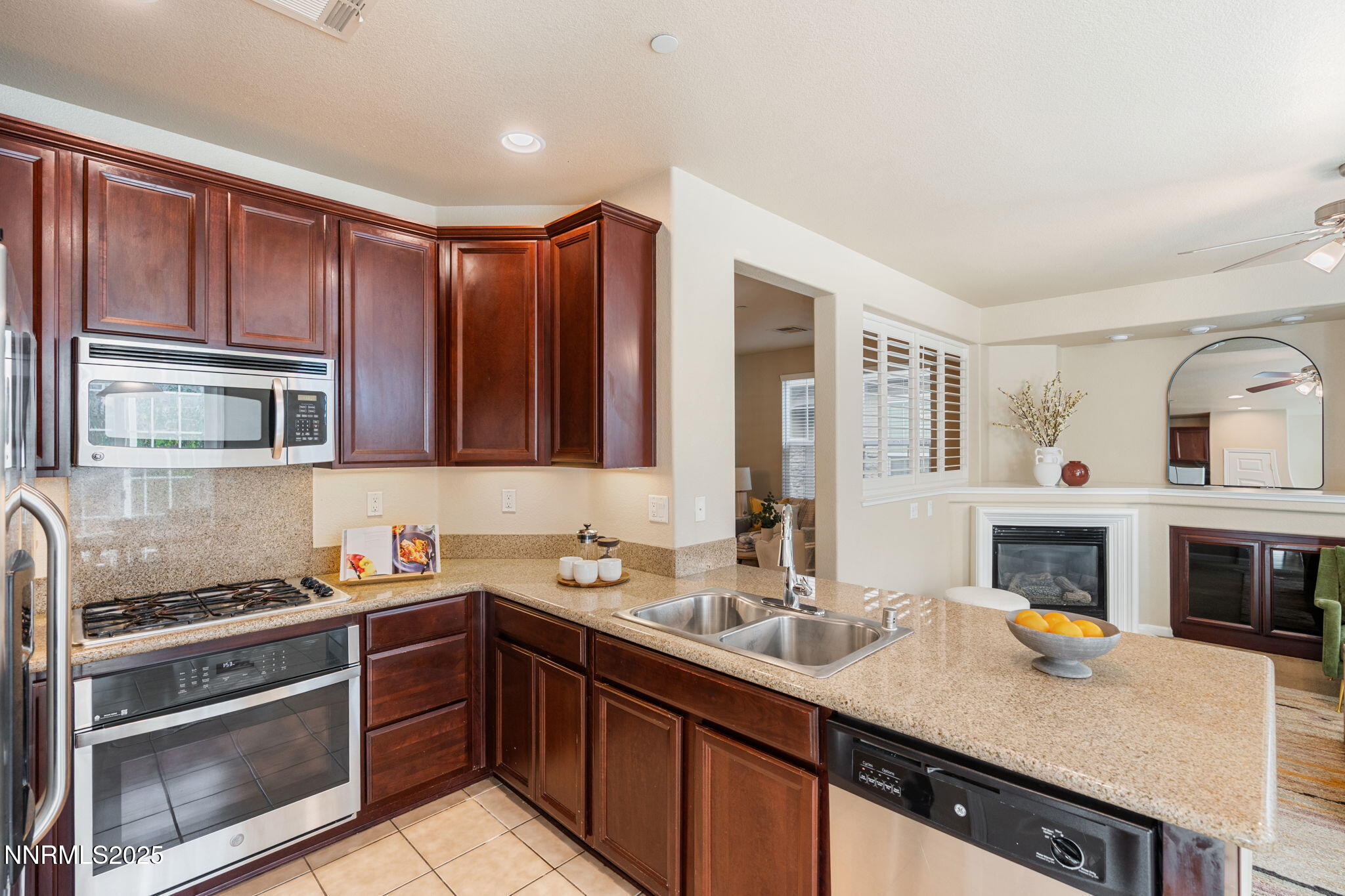 1865 Wind Ranch Road, Unit A Reno, NV 89521 - Photo 5 of 30 a kitchen with stainless steel appliances a stove sink and cabinets