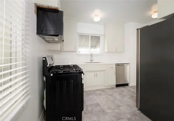 a kitchen with a stove and a refrigerator