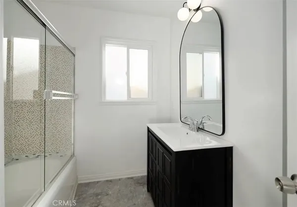 a bathroom with a sink a shower and a mirror