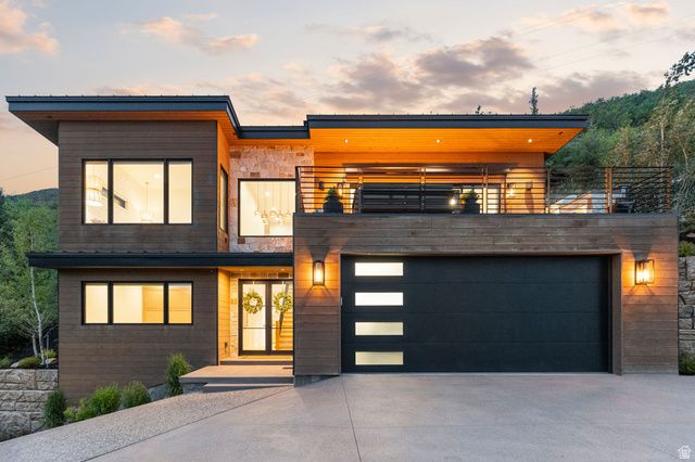1400 Weber Wild Road Oakley, UT 84055 - Photo 2 of 55 Modern exterior featuring dark wood-finish siding, stone accents, and a flat roofline