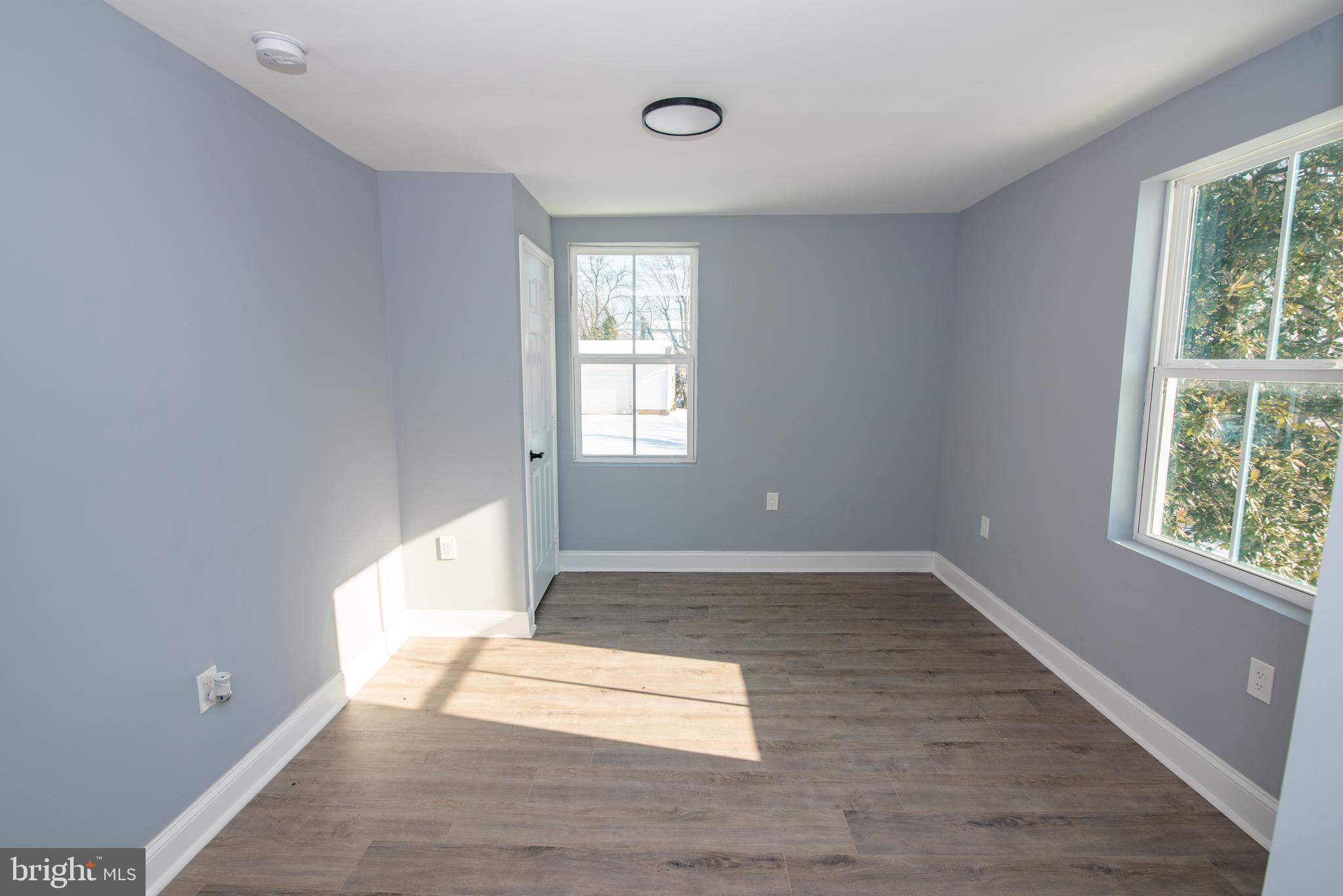 2900 Scherer Avenue Baltimore, MD 21234 - Photo 13 of 37 an empty room with wooden floor and windows
