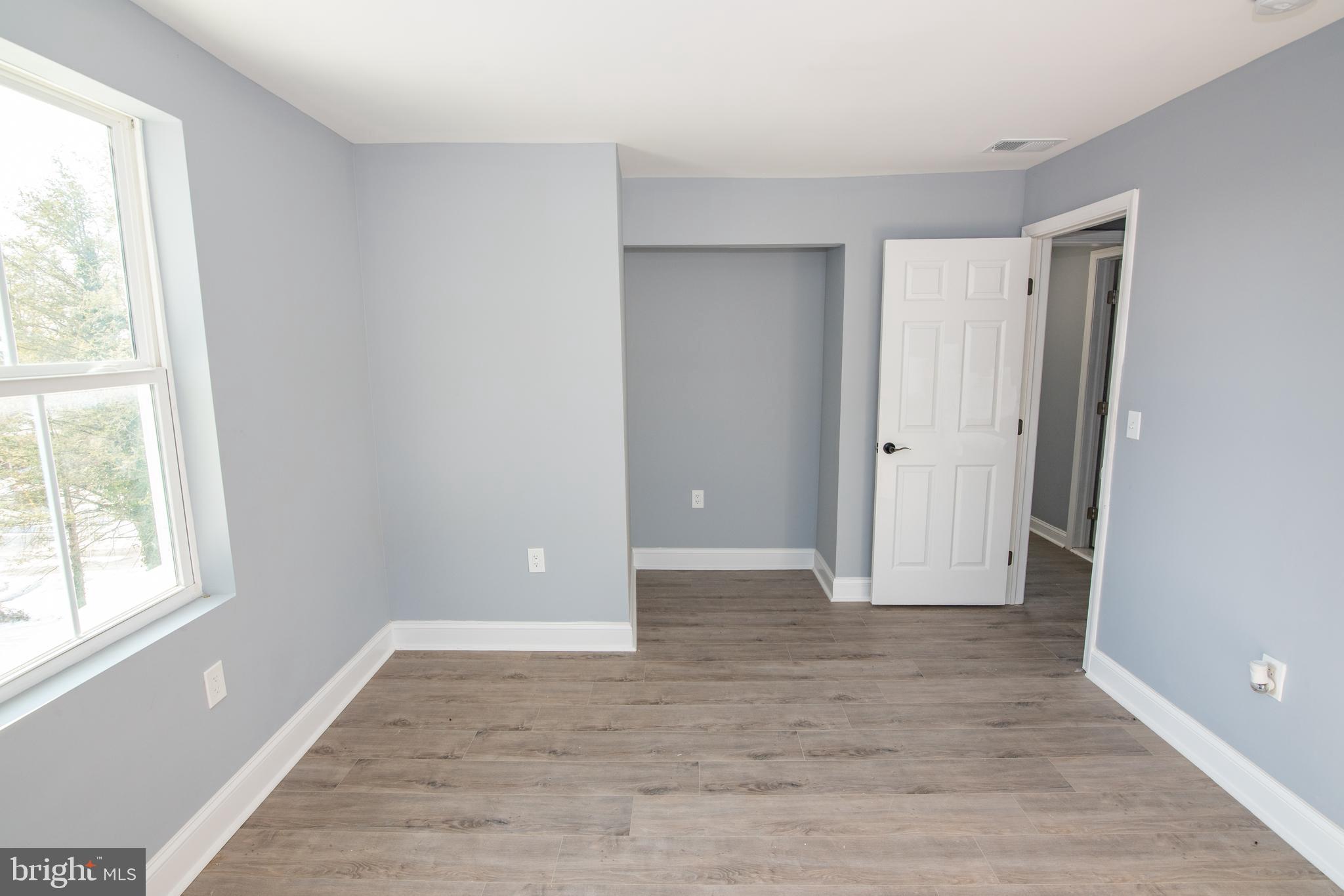 2900 Scherer Avenue Baltimore, MD 21234 - Photo 14 of 37 a view of an empty room with wooden floor and a window