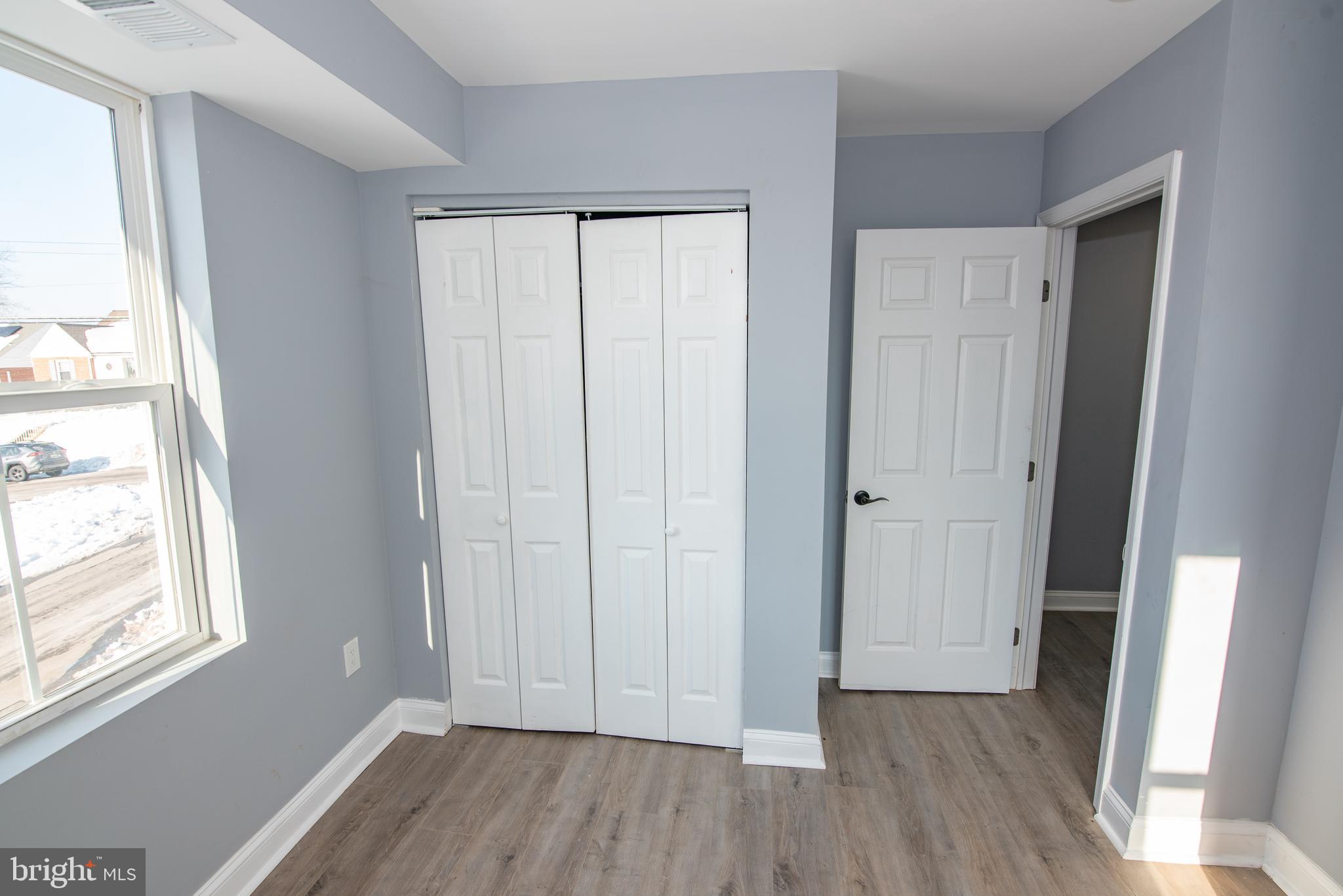 2900 Scherer Avenue Baltimore, MD 21234 - Photo 18 of 37 an empty room with wooden floor and windows