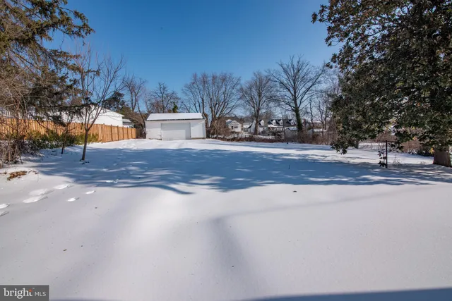 a view of white house with a yard