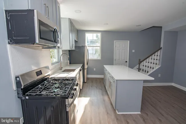 a kitchen with a stove and a refrigerator