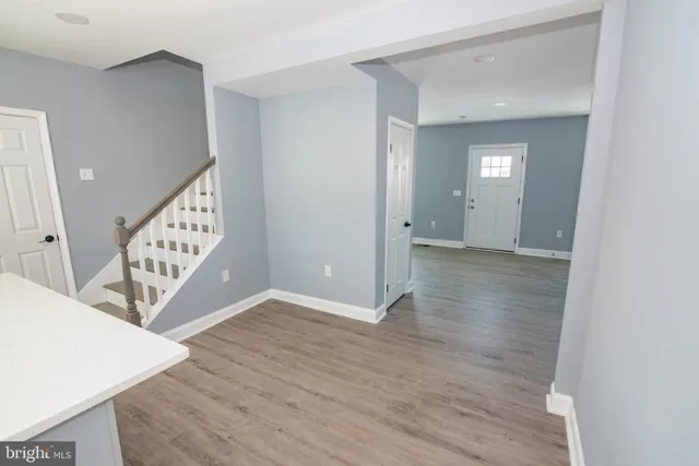 a view of an entryway with wooden floor