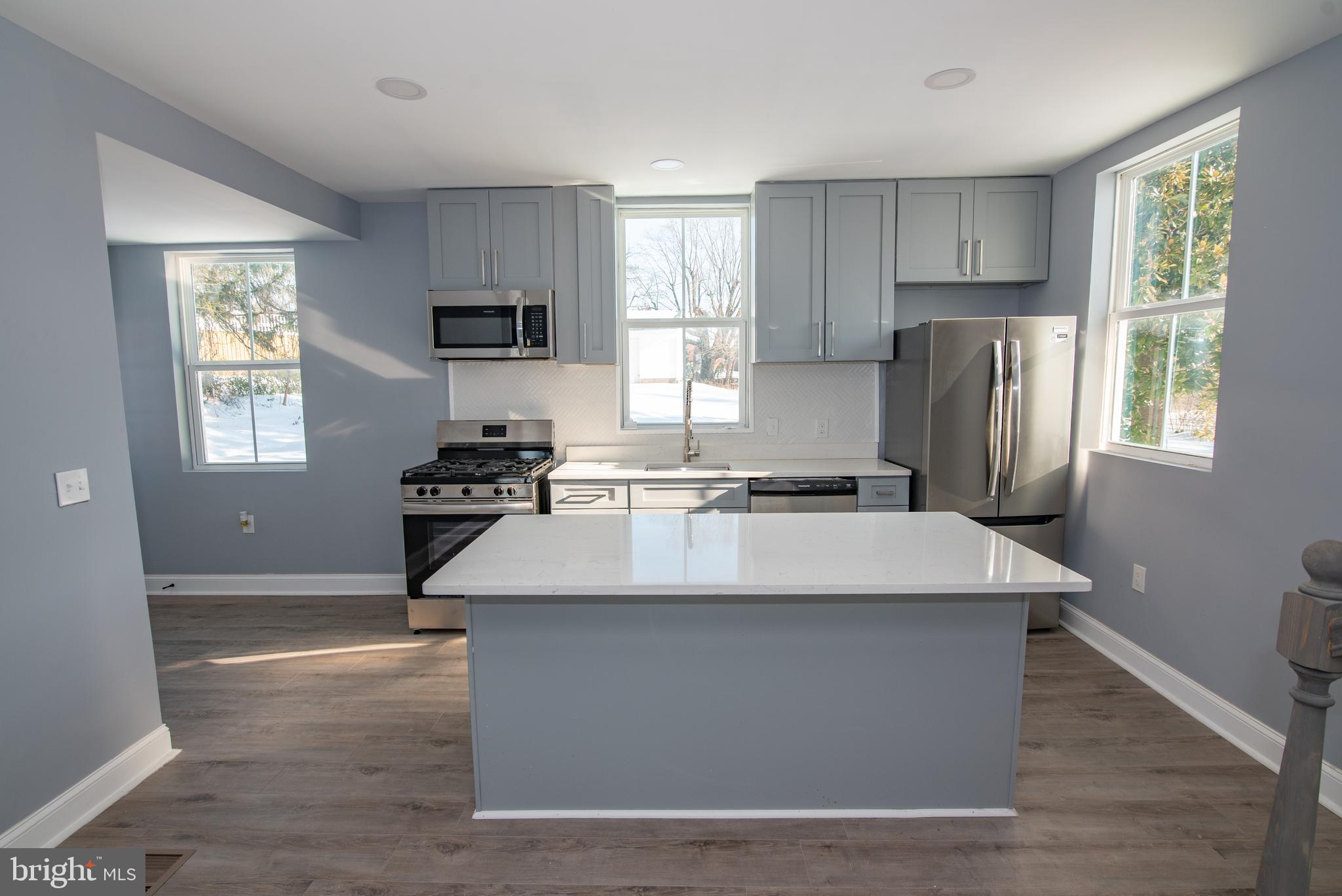 2900 Scherer Avenue Baltimore, MD 21234 - Photo 8 of 37 a kitchen with kitchen island a sink wooden floor and a window