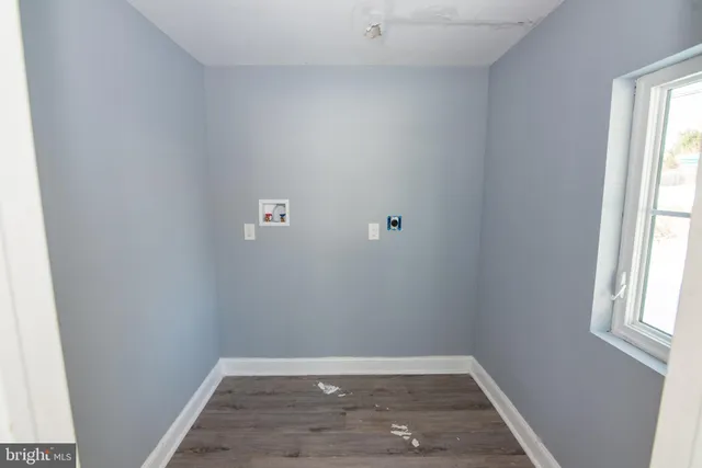 a view of a small space with wooden floor and a window