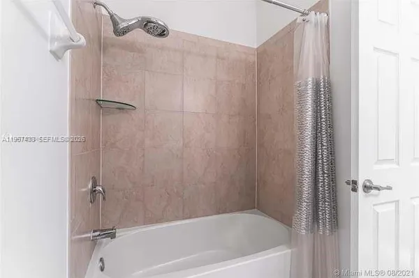 a bathroom with a granite countertop sink toilet and mirror