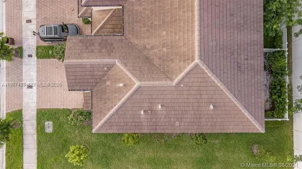an aerial view of residential houses with outdoor space and lake view