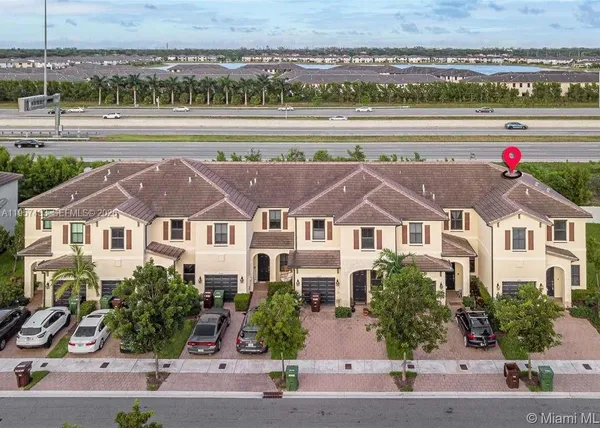 an aerial view of a house with a yard and potted plants