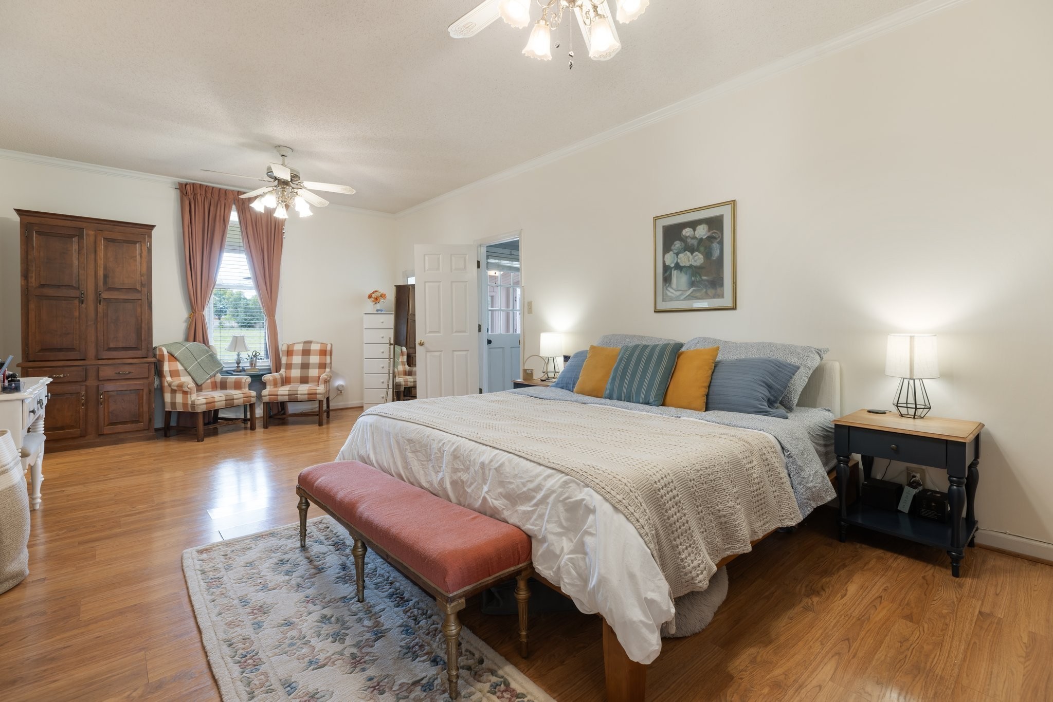 3310 Booker Ridge Road Mount Pleasant, TN 38474 - Photo 15 of 40 a spacious bedroom with a bed a chandelier and a large window