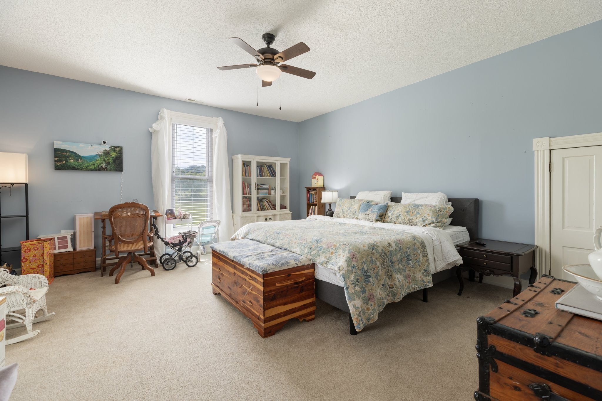 3310 Booker Ridge Road Mount Pleasant, TN 38474 - Photo 28 of 40 a spacious bedroom with a bed and a chandelier