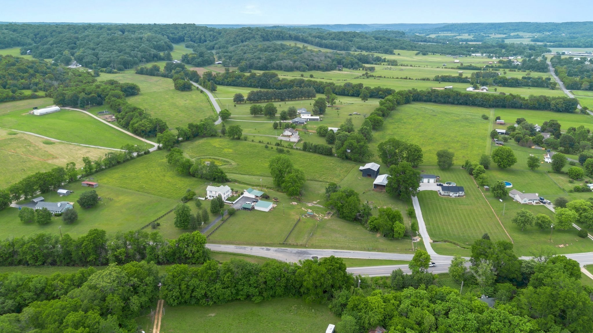 3310 Booker Ridge Road Mount Pleasant, TN 38474 - Photo 9 of 40 an aerial view of green landscape with trees houses and lake view