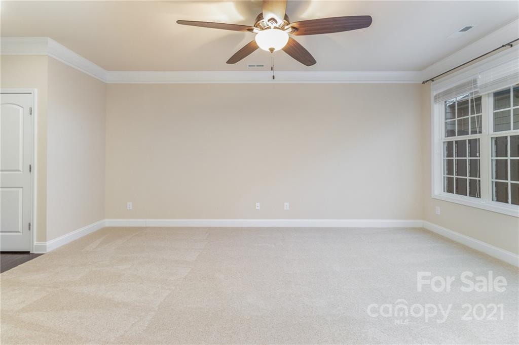 2263 Eversham Drive Northwest Concord, NC 28027 - Photo 12 of 21 an empty room with windows and fan