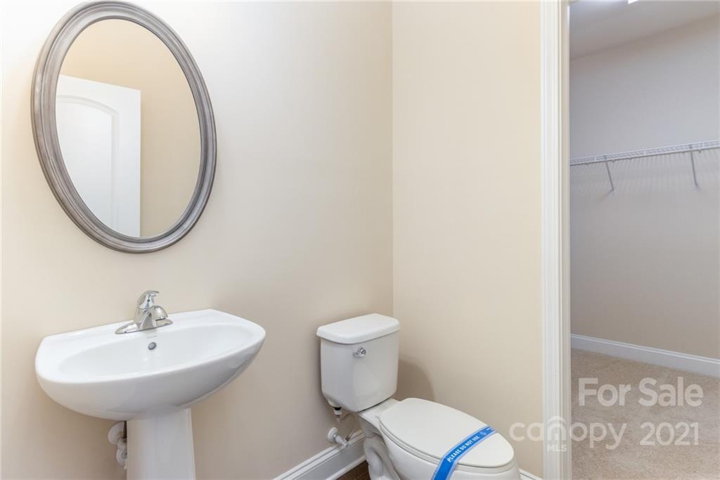 2263 Eversham Drive Northwest Concord, NC 28027 - Photo 16 of 21 a bathroom with a sink a toilet and a mirror