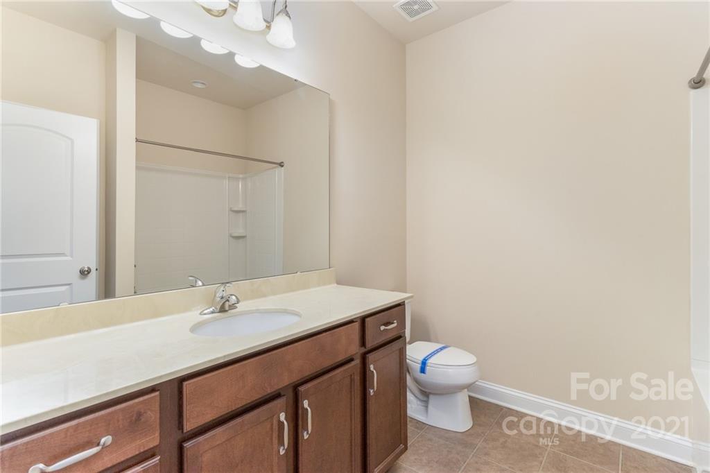 2263 Eversham Drive Northwest Concord, NC 28027 - Photo 17 of 21 a bathroom with a sink a toilet and a mirror