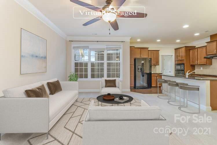 2263 Eversham Drive Northwest Concord, NC 28027 - Photo 2 of 21 a living room with furniture and a chandelier