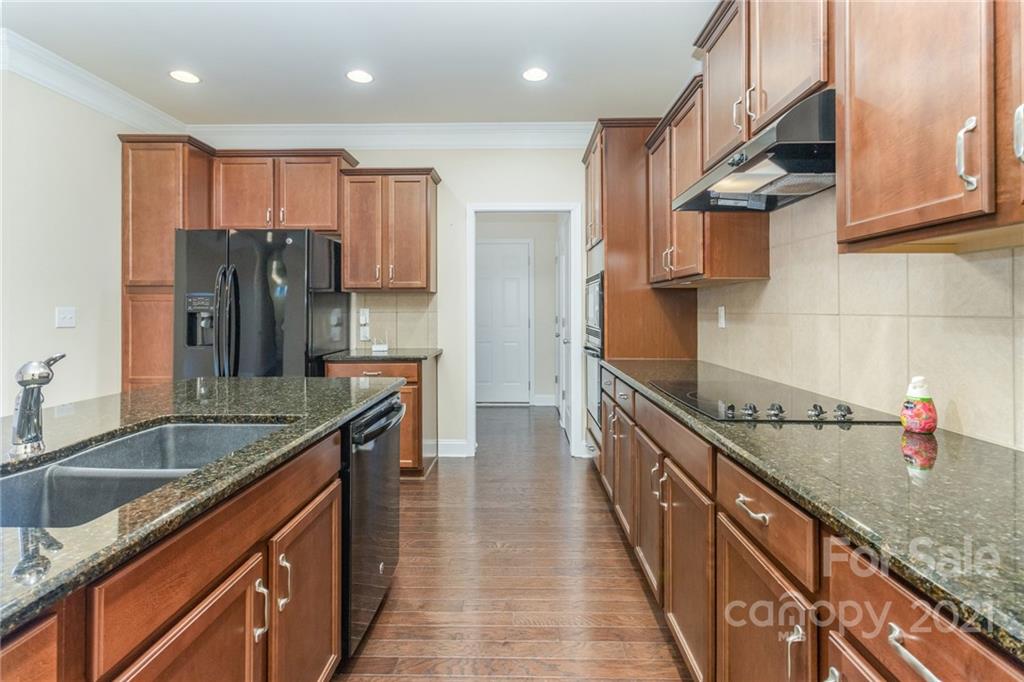 2263 Eversham Drive Northwest Concord, NC 28027 - Photo 4 of 21 a kitchen with stainless steel appliances granite countertop a sink a stove and a refrigerator